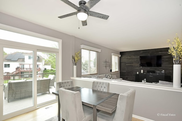2012 Spring Creek Ln, Mchenry, IL 60050 - dining area featuring plenty of natural light, ceiling fan, light wood finished floors, and an accent wall