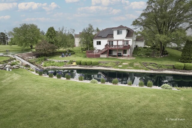 2012 Spring Creek Ln, Mchenry, IL 60050 - back of house with a wooden deck, stairway, solar panels, and a yard