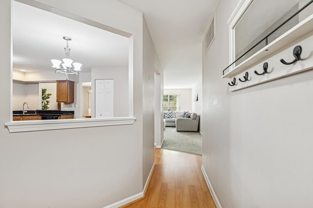 909 Ann Arbor Ln Unit A, Vernon Hills, IL 60061 - corridor featuring light wood finished floors and a chandelier