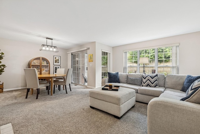 909 Ann Arbor Ln Unit A, Vernon Hills, IL 60061 - carpeted living room with a chandelier and baseboards