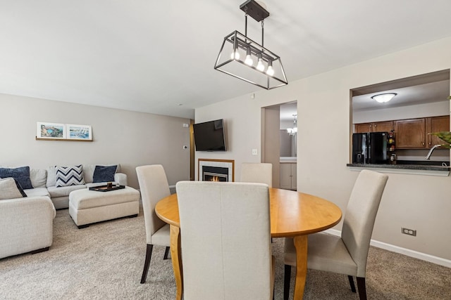 909 Ann Arbor Ln Unit A, Vernon Hills, IL 60061 - dining area with light colored carpet, a tile fireplace, and a chandelier
