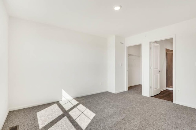 2167 Yellowstone Blvd, Mundelein, IL 60060 - unfurnished bedroom featuring dark colored carpet, a spacious closet, and recessed lighting