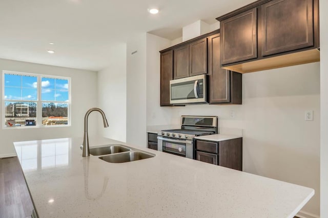 2167 Yellowstone Blvd, Mundelein, IL 60060 - kitchen with stainless steel appliances, dark brown cabinetry, light stone countertops, recessed lighting, and wood finished floors
