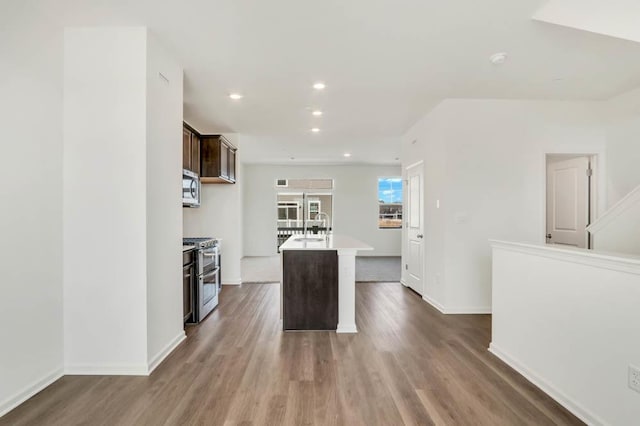 2167 Yellowstone Blvd, Mundelein, IL 60060 - kitchen featuring stainless steel appliances, light countertops, dark wood-type flooring, a center island with sink, and recessed lighting