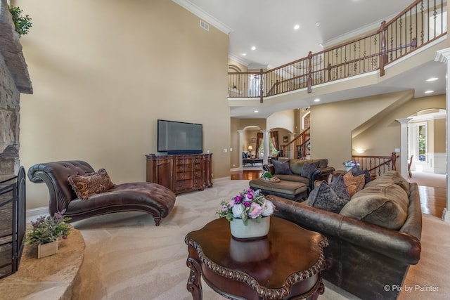 675 Oak Ln, South Elgin, IL 60177 - living room with a towering ceiling, ornamental molding, decorative columns, arched walkways, and carpet flooring