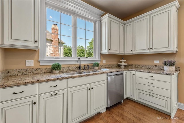675 Oak Ln, South Elgin, IL 60177 - kitchen with stainless steel dishwasher, light wood-type flooring, white cabinets, and light stone counters