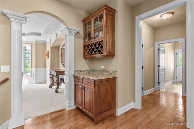 675 Oak Ln, South Elgin, IL 60177 - indoor dry bar with decorative columns, arched walkways, and light wood-style flooring