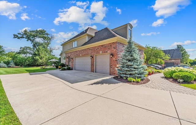 675 Oak Ln, South Elgin, IL 60177 - view of home's exterior featuring brick siding, driveway, and a garage