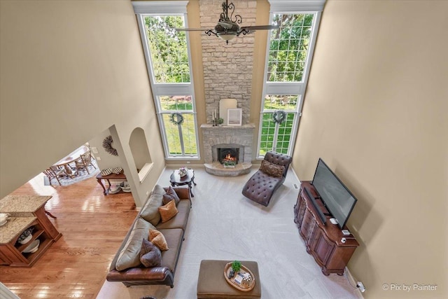 675 Oak Ln, South Elgin, IL 60177 - living area with a stone fireplace and wood finished floors