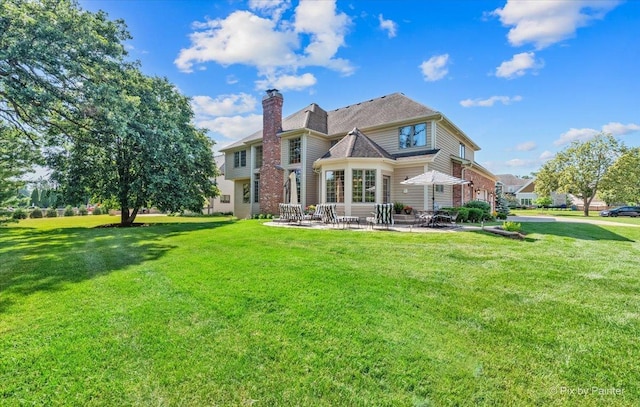 675 Oak Ln, South Elgin, IL 60177 - back of house featuring a patio, a chimney, and a yard