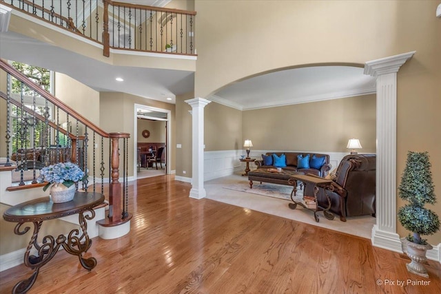 675 Oak Ln, South Elgin, IL 60177 - living room with ornate columns, wood finished floors, arched walkways, ornamental molding, and a wainscoted wall
