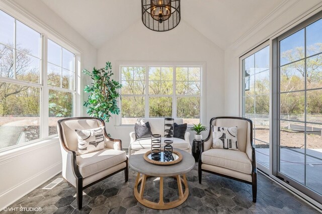 sunroom / solarium featuring vaulted ceiling and healthy amount of natural light