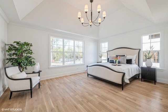 bedroom with a chandelier, vaulted ceiling, and light wood-type flooring