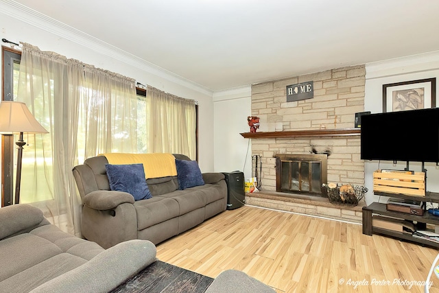 12977 W 9th St, Zion, IL 60099 - living room featuring ornamental molding, wood finished floors, and a stone fireplace