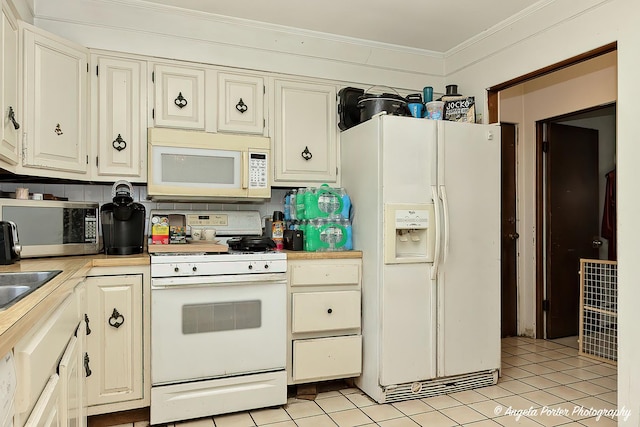 12977 W 9th St, Zion, IL 60099 - kitchen with white appliances, ornamental molding, light countertops, and light tile patterned floors
