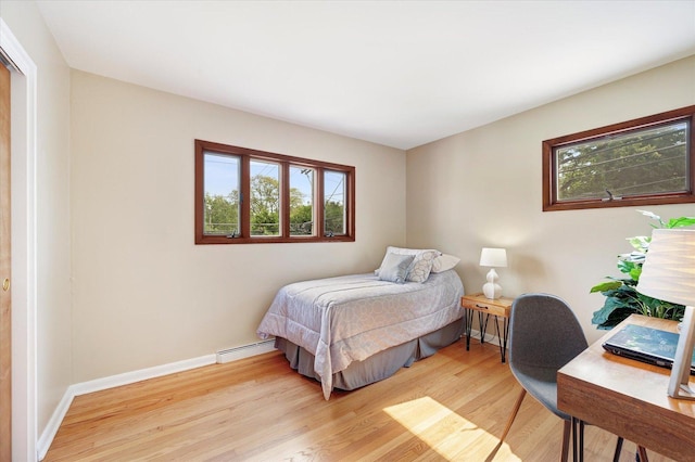 602 E Park Ave, Elmhurst, IL 60126 - bedroom with a baseboard heating unit, light wood finished floors, and a desk