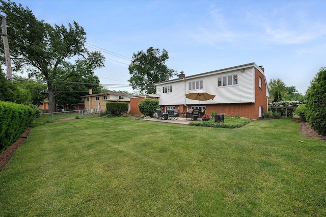 602 E Park Ave, Elmhurst, IL 60126 - back of property with a chimney, a patio, and brick siding