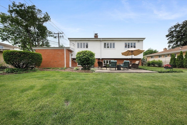 602 E Park Ave, Elmhurst, IL 60126 - back of property featuring brick siding, a patio area, a lawn, and a chimney