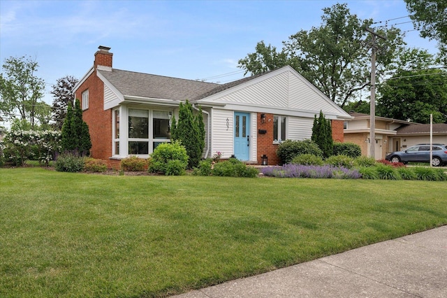 602 E Park Ave, Elmhurst, IL 60126 - view of front of property featuring a chimney, brick siding, a front lawn, and a shingled roof