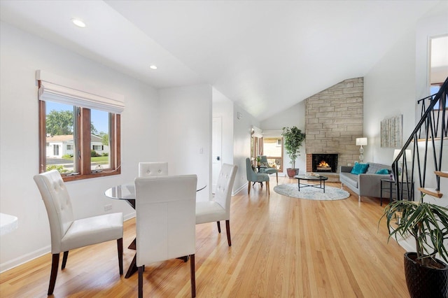 602 E Park Ave, Elmhurst, IL 60126 - dining area with stairway, light wood-style floors, a fireplace, vaulted ceiling, and recessed lighting