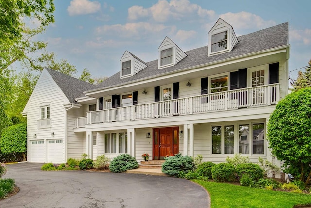 2120 Wilmette Ave, Wilmette, IL 60091 - cape cod house featuring a balcony, an attached garage, asphalt driveway, and roof with shingles