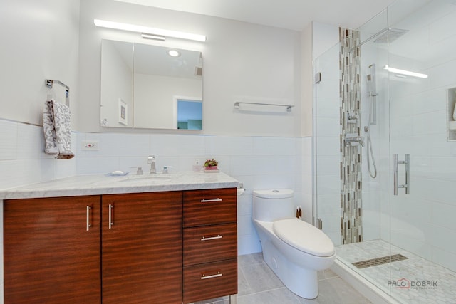 2120 Wilmette Ave, Wilmette, IL 60091 - bathroom featuring vanity, tile patterned flooring, tile walls, a stall shower, and wainscoting
