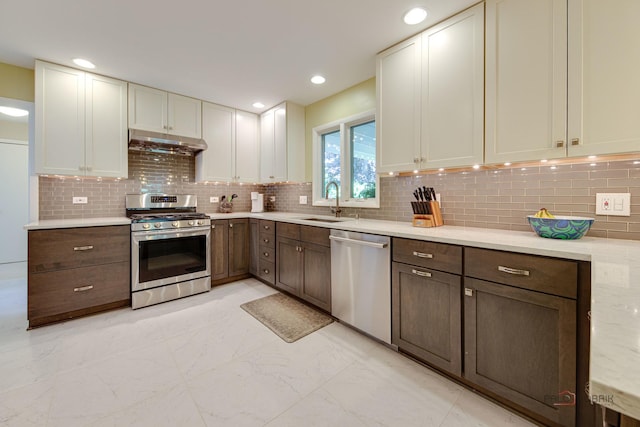 2120 Wilmette Ave, Wilmette, IL 60091 - kitchen with stainless steel appliances, under cabinet range hood, light marble finish floors, decorative backsplash, and recessed lighting