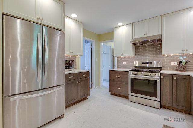 2120 Wilmette Ave, Wilmette, IL 60091 - kitchen with stainless steel appliances, under cabinet range hood, light countertops, backsplash, and white cabinetry