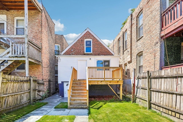 2922 W Polk St, Chicago, IL 60612 - rear view of house featuring a fenced backyard, a wooden deck, and stairway