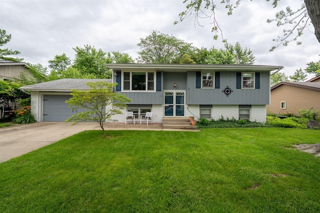 212 Rebecca Ln, Normal, IL 61761 - raised ranch featuring driveway, a front lawn, brick siding, entry steps, and a garage