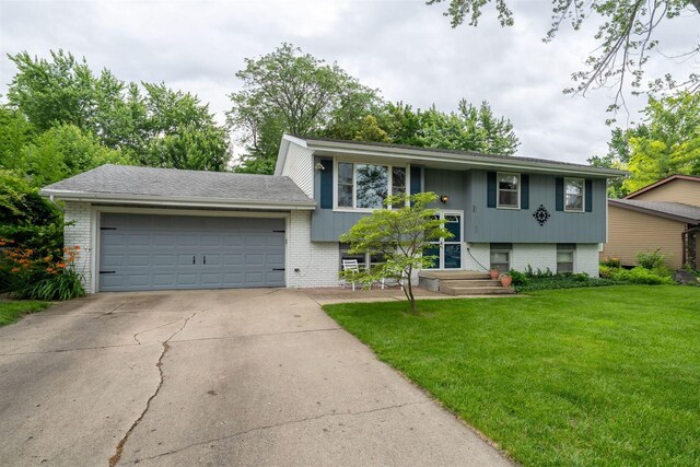 212 Rebecca Ln, Normal, IL 61761 - view of front facade with brick siding, a garage, a front lawn, and concrete driveway