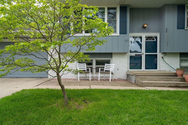 212 Rebecca Ln, Normal, IL 61761 - doorway to property with brick siding and a lawn