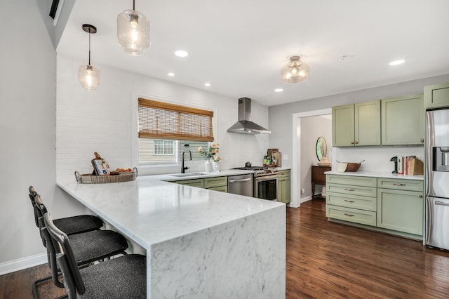 17526 W Windhaven Ct, Grayslake, IL 60030 - kitchen featuring green cabinets, wall chimney range hood, appliances with stainless steel finishes, a peninsula, and dark wood-type flooring