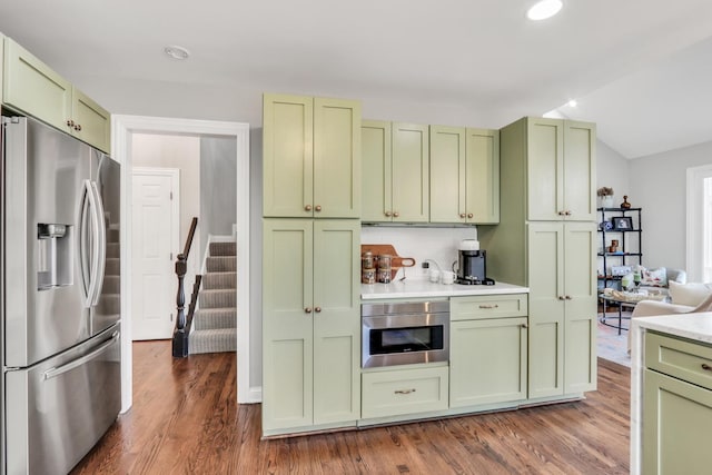 17526 W Windhaven Ct, Grayslake, IL 60030 - kitchen with green cabinetry, stainless steel appliances, dark wood-style floors, light countertops, and lofted ceiling