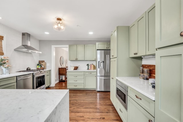17526 W Windhaven Ct, Grayslake, IL 60030 - kitchen with green cabinets, wall chimney range hood, appliances with stainless steel finishes, dark wood finished floors, and recessed lighting