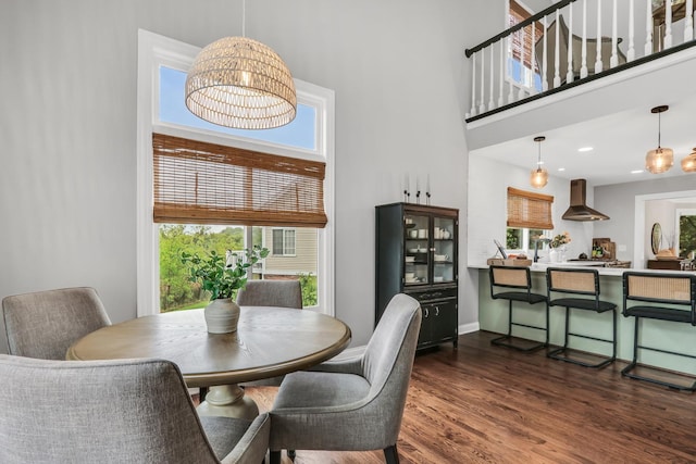 17526 W Windhaven Ct, Grayslake, IL 60030 - dining room featuring wood finished floors, a chandelier, and a towering ceiling