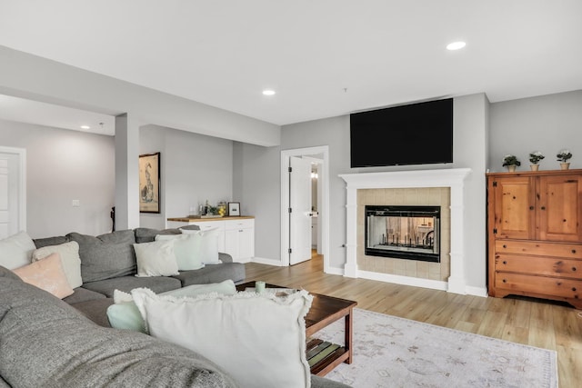 17526 W Windhaven Ct, Grayslake, IL 60030 - living room featuring light wood-style flooring, a tiled fireplace, and recessed lighting