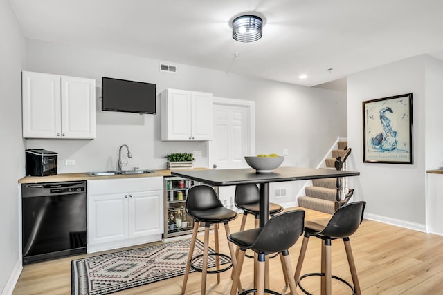 17526 W Windhaven Ct, Grayslake, IL 60030 - kitchen with black dishwasher, light wood-type flooring, white cabinetry, light countertops, and recessed lighting
