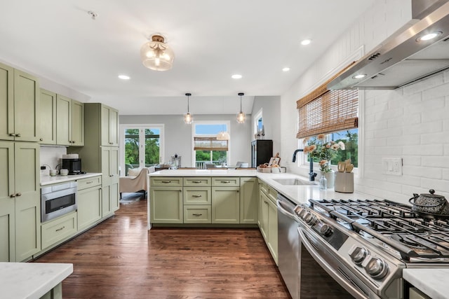 17526 W Windhaven Ct, Grayslake, IL 60030 - kitchen with green cabinetry, stainless steel appliances, extractor fan, a peninsula, and light countertops