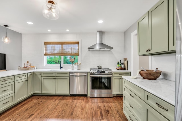17526 W Windhaven Ct, Grayslake, IL 60030 - kitchen with green cabinetry, stainless steel appliances, wall chimney exhaust hood, dark wood-type flooring, and recessed lighting