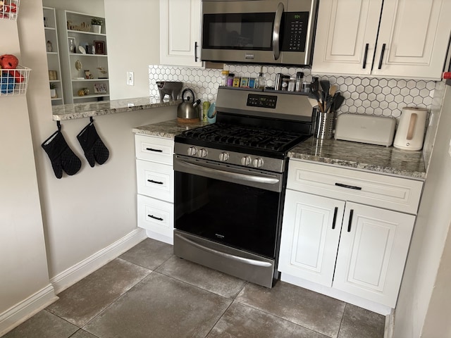 2119 S 20th Ave, Broadview, IL 60155 - kitchen featuring stainless steel appliances, decorative backsplash, stone counters, dark tile patterned floors, and white cabinets