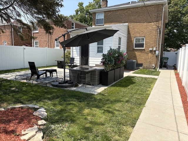 2119 S 20th Ave, Broadview, IL 60155 - back of house with brick siding, a fenced backyard, a patio area, and a chimney