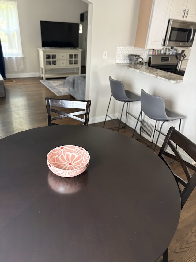 2119 S 20th Ave, Broadview, IL 60155 - dining room with baseboards and wood finished floors