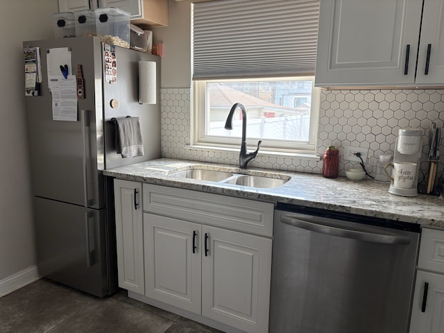 2119 S 20th Ave, Broadview, IL 60155 - kitchen with dishwasher, freestanding refrigerator, white cabinets, decorative backsplash, and light stone countertops