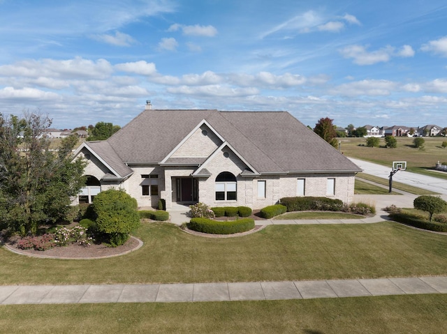 305 Orchard Ln, Beecher, IL 60401 - french country style house featuring a front lawn, brick siding, and a shingled roof