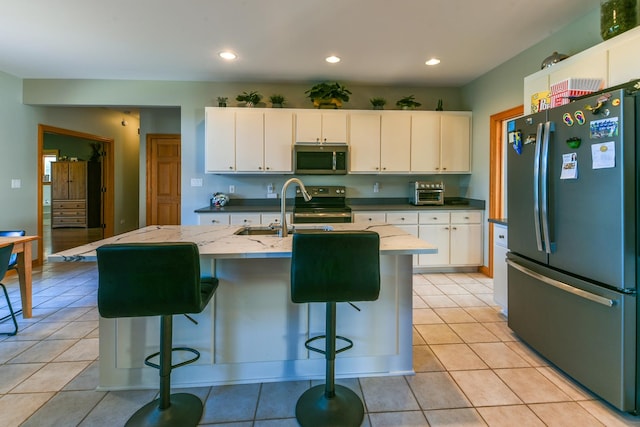 305 Orchard Ln, Beecher, IL 60401 - kitchen featuring appliances with stainless steel finishes, recessed lighting, white cabinets, a breakfast bar, and a center island with sink