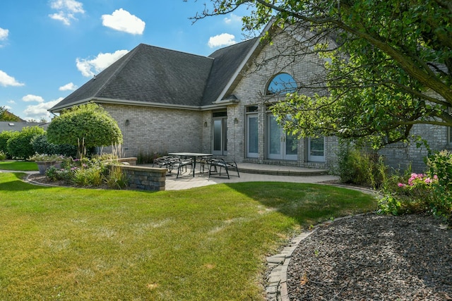 305 Orchard Ln, Beecher, IL 60401 - back of property featuring brick siding, a patio, a yard, and roof with shingles
