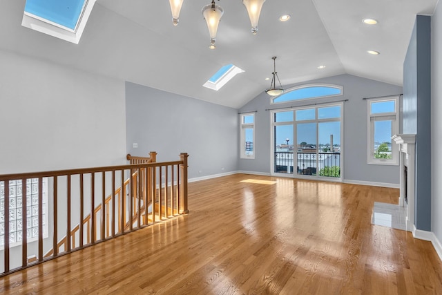 7153 W Irving Park Rd Unit 3, Chicago, IL 60634 - empty room featuring a skylight, plenty of natural light, lofted ceiling, recessed lighting, and wood finished floors