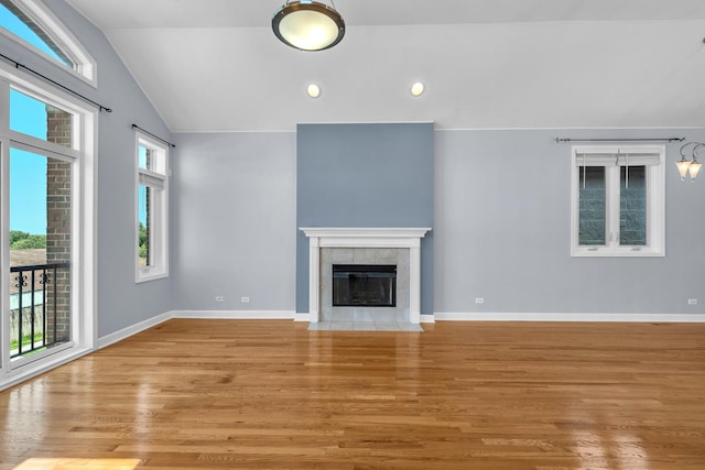 7153 W Irving Park Rd Unit 3, Chicago, IL 60634 - unfurnished living room featuring vaulted ceiling, light wood-style floors, a fireplace, and recessed lighting