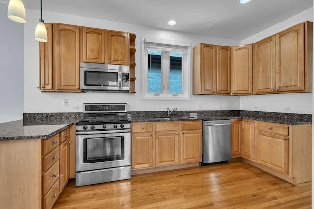 7153 W Irving Park Rd Unit 3, Chicago, IL 60634 - kitchen featuring stainless steel appliances, recessed lighting, dark stone counters, light wood-type flooring, and hanging light fixtures